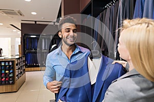 Handsome Business Man And Woman Fashion Shop, Customers Choosing Clothes In Retail Store