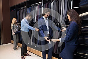 Handsome Business Man And Woman Fashion Shop, Customers Choosing Clothes In Retail Store