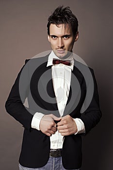 Handsome businesslike man with dark hair in elegant suit