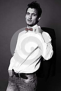 Handsome businesslike man with dark hair in elegant suit