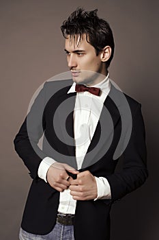 Handsome businesslike man with dark hair in elegant suit