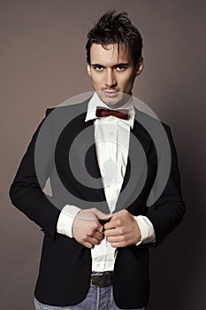 Handsome businesslike man with dark hair in elegant suit photo