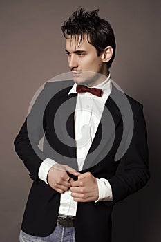 Handsome businesslike man with dark hair in elegant suit photo