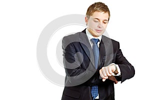 Handsome businessman checking his wrist-watch