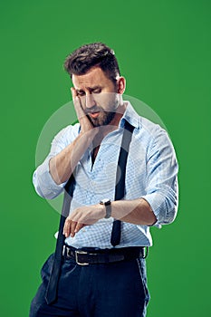 Handsome businessman checking his wrist-watch Isolated on white background