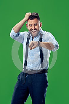 Handsome businessman checking his wrist-watch Isolated on white background