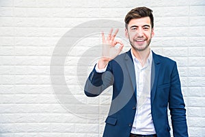 Handsome businessman doing okay or alright gesture. Business and