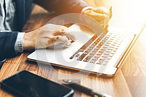 Handsome businessman Hands holding credit card and using laptop. Online shopping