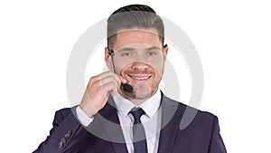 Handsome businessman with headset looking into camera and smiling on white background.