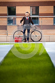 Handsome businessman and his bicycle