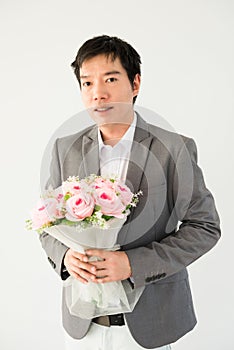 Handsome businessman holding flower bouquet