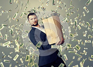 Handsome businessman holding money