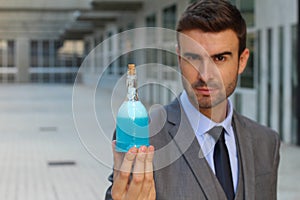 Handsome businessman holding a potion