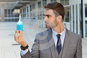 Handsome businessman holding a potion