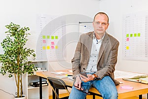 Handsome Businessman Holding Smartphone At Office