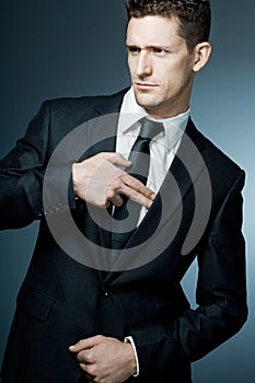 Handsome businessman making gun gesture.