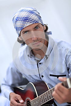 Handsome businessman playing the guitar in office