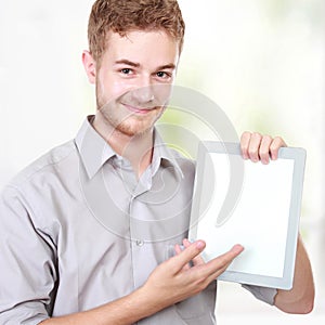Handsome businessman presenting using blank tablet pc