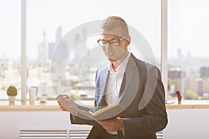 Handsome businessman reading notes