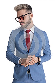 Handsome businessman rubbing palms with a tough look