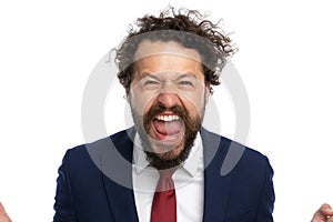 Handsome businessman screaming at the camera out of rage