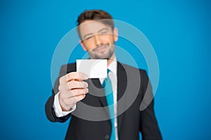 Handsome businessman showing blank business card