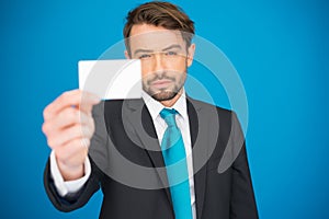 Handsome businessman showing blank business card