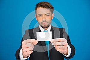 Handsome businessman showing blank business card