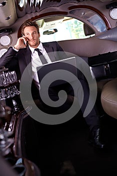 Handsome businessman sitting in limousine