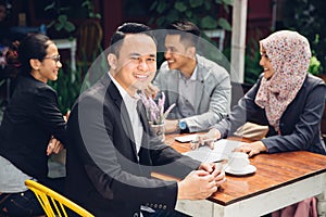 Handsome businessman smiling at the camera