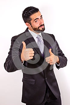 Handsome businessman in suit giving thumbs up and having fun