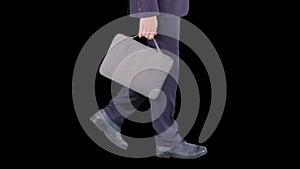 Handsome businessman in a suit walks with a briefcase, Alpha Channel