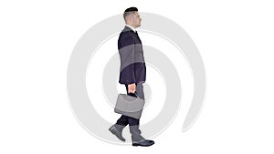Handsome businessman in a suit walks with a briefcase on white background.