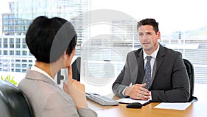 Handsome businessman talking with interviewee