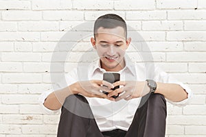 Handsome businessman texting on mobilephone