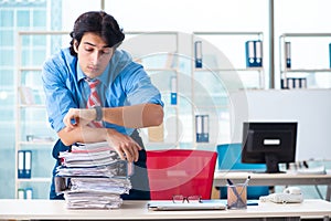 The handsome businessman unhappy with excessive work in the office