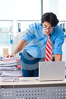 The handsome businessman unhappy with excessive work in the office