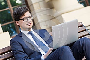 Handsome businessman using laptop