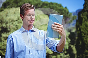 Handsome businessman using tablet computer