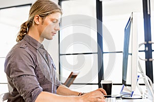 Handsome businessman working at computer