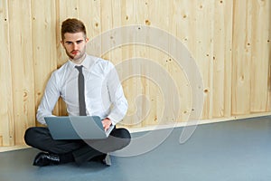 Handsome Businessman Working on Laptop at His Office