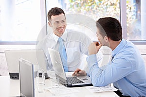 Handsome businessmen chatting in meeting room photo