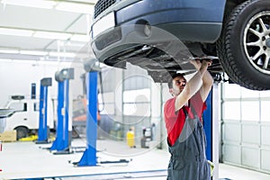 Car mechanic working at automotive service center