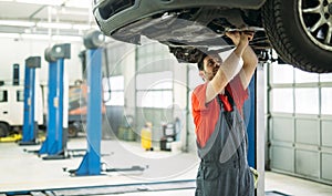 Car mechanic working at automotive service center