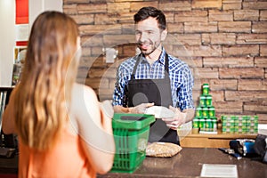 Handsome cashier enjoying his work