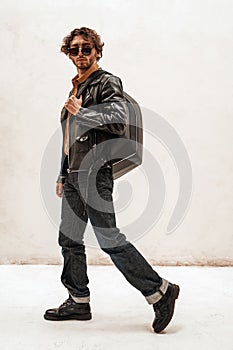 Handsome and casual-looking man posing for the photoshoot on the white background, full height
