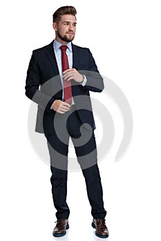 Handsome casual man adjusting his red tie