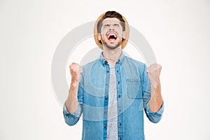 Handsome casual man showing excitement isolated on white background