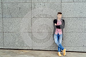 Handsome casual young man in plaid shirt and jacket posing