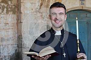 Handsome catholic priest smiling in church